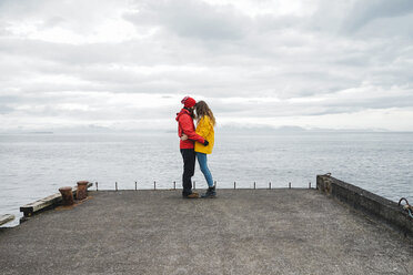 Iceland, North of Iceland, young couple standing on jetty - AFVF00601
