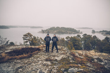 Sweden, Sodermanland, two men standing at archipelago landscape - GUSF00941