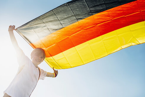 Junge, begeistert von der Fußballweltmeisterschaft, schwenkt die deutsche Flagge - MJF02325