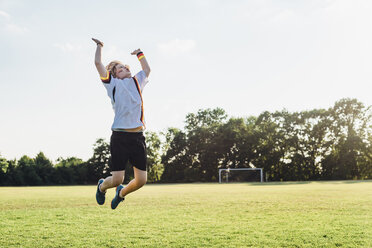 Boy wearing German football shirt playing soccer - MJF02331