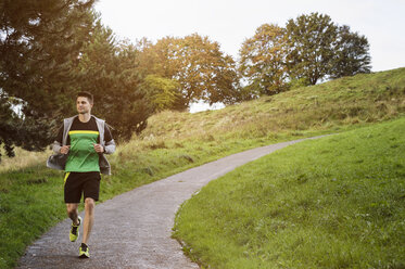 Young athlete jogging in park - CUF20451