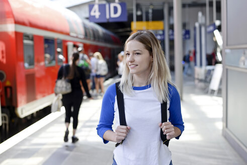 Portrait of blond woman with backpack on platform - BFRF01828