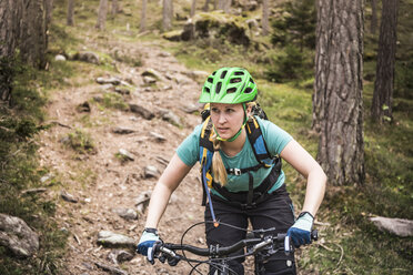 Woman mountain biking, Bozen, South Tyrol, Italy - CUF20951