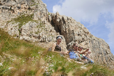 Hikers resting on rocky hillside, Austria - CUF21053