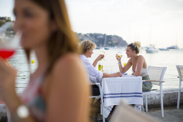 Background view of young couple at waterfront restaurant, Majorca, Spain - CUF21104