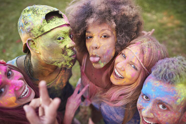 Portrait of group of friends at festival, covered in colourful powder paint - CUF21179