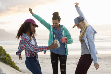 Woman friends taking off their clothes and throwing while running towards  the ocean. Excited women going for swimming in the sea on a summer day  Stock Photo - Alamy