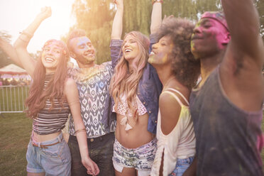 Group of friends at festival, covered in colourful powder paint - CUF21223