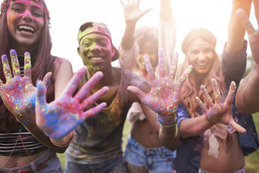 Portrait of group of friends at festival, covered in colourful powder paint - CUF21224