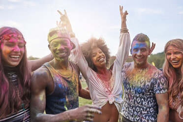 Portrait of group of friends at festival, covered in colourful powder paint - CUF21226