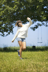 Young woman jumping around on meadow - MAEF12629