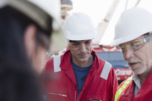 Engineers in brainstorming session on oil rig - ISF07494