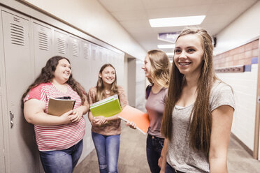 Four teenage high school girls talking in locker room - ISF07532