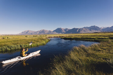 Man kayaking on river, Mammoth Lakes, California, USA - ISF07612