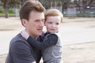 Young boy hugging father, worried expression on boy's face - ISF07705