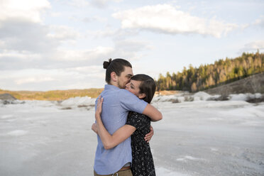 Couple hugging on snow-covered landscape, Ottawa, Ontario - ISF07742