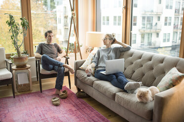 Mid adult couple relaxing in living room - ISF07759