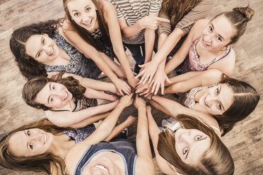 Overhead portrait of teenagers in circle practicing dance in high school classroom - ISF07835