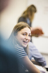 Portrait of female high school student looking back in lesson - ISF07863