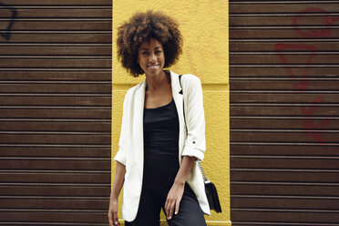 Portrait of fashionable young woman with curly hair - JSMF00220