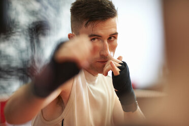 Boxer practising in boxing ring - CUF21412