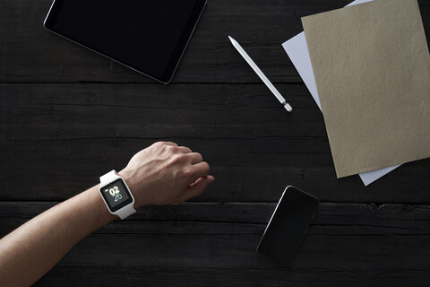 Man wearing smartwatch in office stock photo