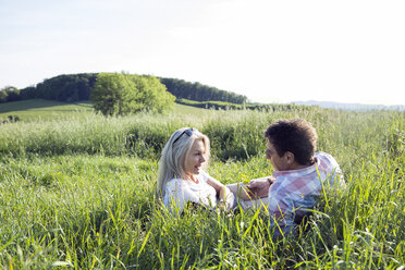 Mature couple lying in field - CUF21506