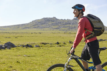 Side view of cyclist cycling on hillside - CUF21555