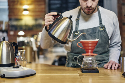 Close up of filter coffee brewing kit and kettle, cafe barista preparing  filter at the counter Stock Photo by benzoix