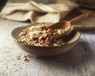 Food, muesli in wooden bowl, pecans, rolled oats, dried fruit, raisins, nuts, vintage - CUF21882