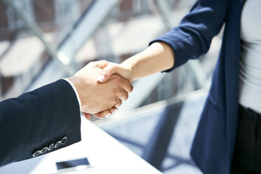 Close-up of handshake of businesswoman and businessman - BSZF00465
