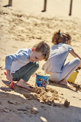 Bruder und Schwester spielen mit Sand am Strand - BEF00130