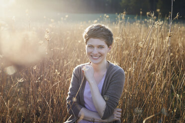 Portrait of smiling woman relaxing in nature - PNEF00639