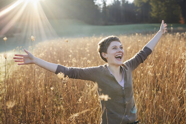 Portrait of laughing woman relaxing in nature - PNEF00641