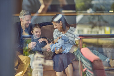 Happy family relaxing on the couch at home - BEF00144