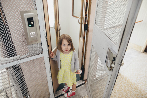 Porträt eines kleinen Mädchens beim Verlassen des Aufzugs, lizenzfreies Stockfoto