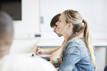 Female student listening in higher education college classroom - CUF22193