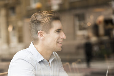 Window view of young businessman in cafe - CUF22258