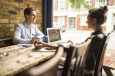 Businessman and woman working in cafe, London, UK - CUF22281