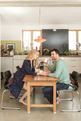 Couple at dining table drinking coffee - CUF22473