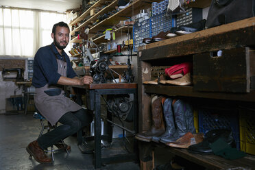 Portrait of male cobbler in traditional shoe workshop - ISF07974