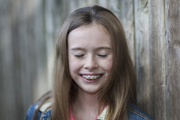 Portrait of girl with dental brace, eyes closed smiling - ISF08079