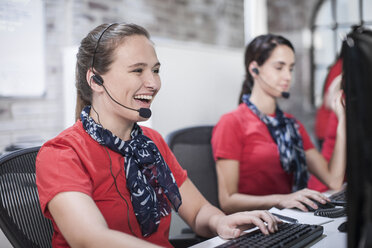 Row of female telephonists working in call centre - ISF08085