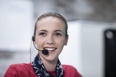 Portrait of female telephonist working in call centre - ISF08086