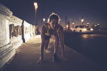 Young woman in start position before run - ISF08275