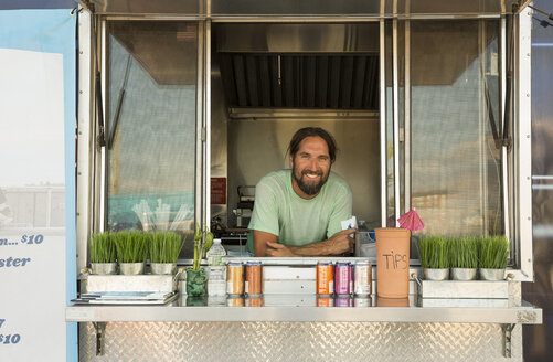 Portrait of man in fast food trailer - ISF08296