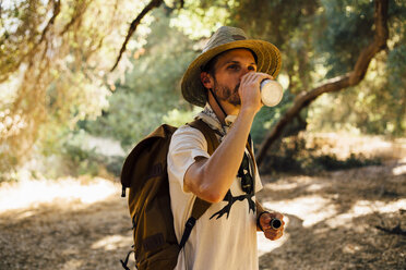 Hiker drinking from water bottle, Malibu Canyon, California, USA - ISF08308