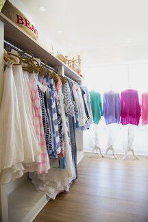 Colorful Clorhes On Racks In A Fashion Boutique Stock Photo