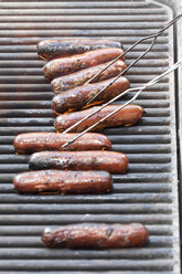 Row of sausages barbecuing on grill - ISF08641