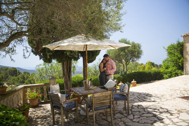 Romantic couple on patio at boutique hotel, Majorca, Spain - CUF22671